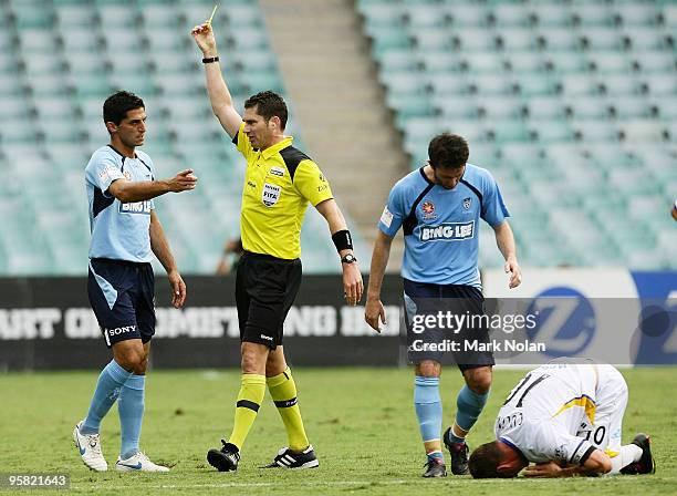 Simon Colosimo of Sydney FC is given a yellow card after a tackle on Jason Culina of the Gold Coast goal during the round 23 A-League match between...