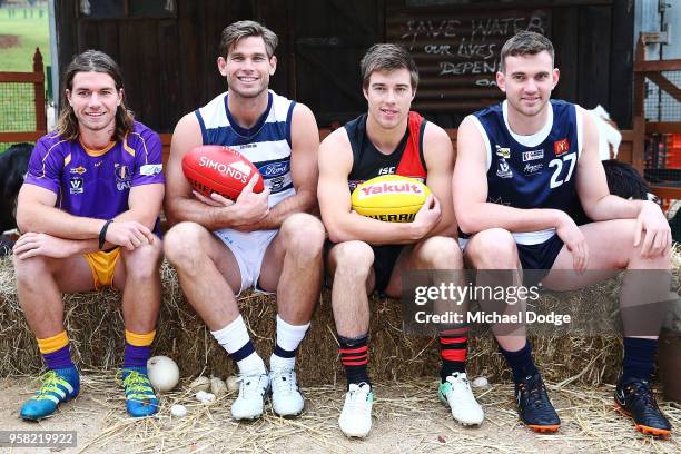 Tom Hawkins of the Cats and Zach Merrett of the Bombers pose with country footballers during the Powercor Country Festival Launch at Melbourne...