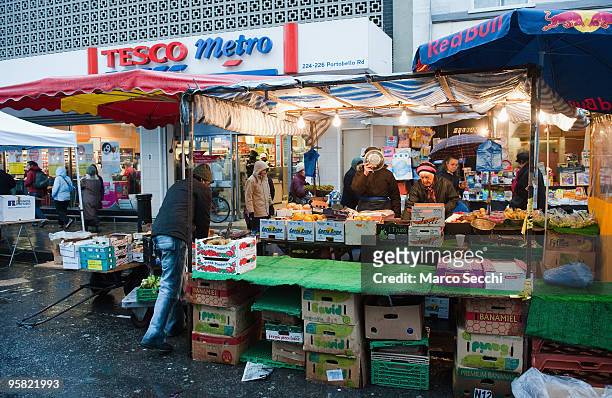 Supermarkets and traditional fruit and veg stalls coexist in the lower part of Portobello Road on January 16, 2010 in London, England. Portobello...