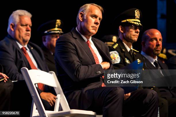 Secretary of Interior Ryan Zinke listens to remarks during a candlelight vigil marking National Police Week on May 13, 2018 in Washington, D.C.