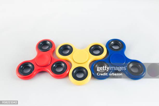 fidget spinners on white - spinning gyroscope stock pictures, royalty-free photos & images
