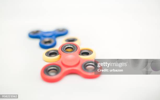 fidget spinners on white - spinning gyroscope stock pictures, royalty-free photos & images