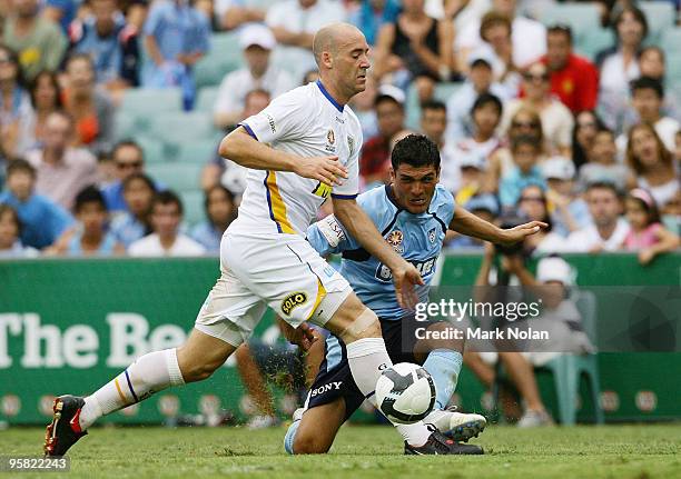 John Aloisi of Sydney FC shoots for goal as Kristian Rees of the Gold Coast defends during the round 23 A-League match between Sydney FC and Gold...