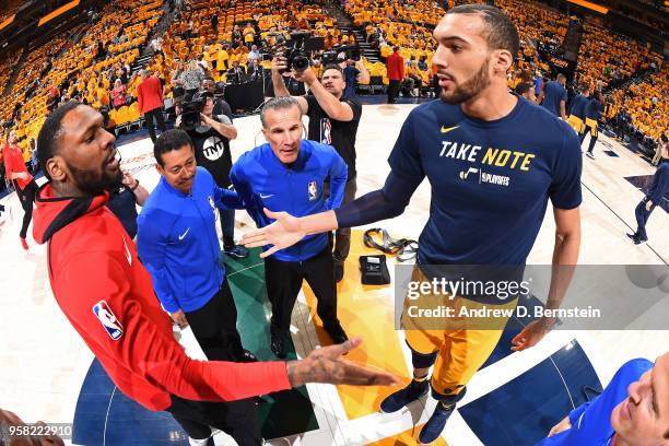 Referee official Ken Mauer speaks to team captains Tarik Black of the Houston Rockets and Rudy Gobert of the Utah Jazz before tip off during Game...