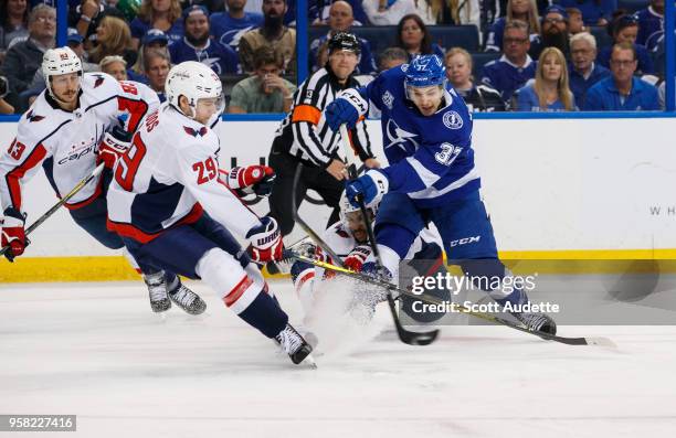 Yanni Gourde of the Tampa Bay Lightning against Christian Djoos and Devante Smith-Pelly of the Washington Capitals during Game Two of the Eastern...