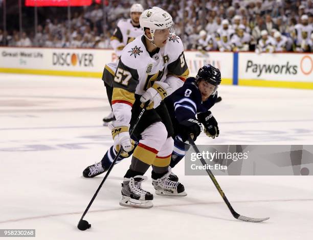 David Perron of the Vegas Golden Knights tries to keep the puck as Andrew Copp of the Winnipeg Jets defends in Game One of the Western Conference...