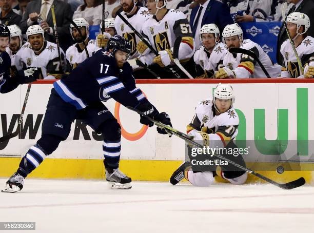 Adam Lowry of the Winnipeg Jets and William Karlsson of the Vegas Golden Knights collide in Game One of the Western Conference Finals during the 2018...