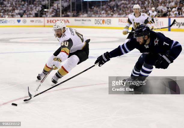 Ryan Carpenter of the Vegas Golden Knights Ben Chiarot of the Winnipeg Jets fight for the puck in Game One of the Western Conference Finals during...