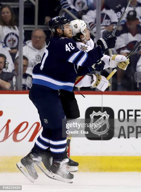 Joel Armia of the Winnipeg Jets and Erik Haula of the Vegas Golden Knights collide in Game One of the Western Conference Finals during the 2018 NHL...