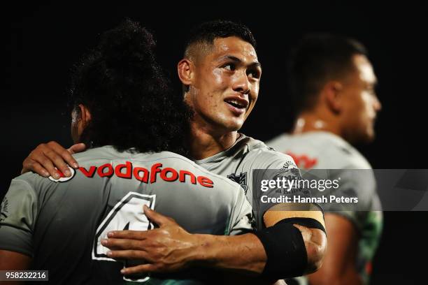 Roger Tuivasa-Sheck hugs Solomone Kata of the Warriors during the round 10 NRL match between the New Zealand Warriors and the Sydney Roosters at Mt...