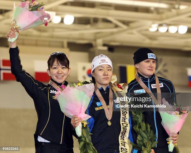 Silver medalist Sayuri Yoshii of Japan, gold medalist Lee Sang-hwa of South Korea and bronze medalist Jenny Wolf of Germany stand on the podium...