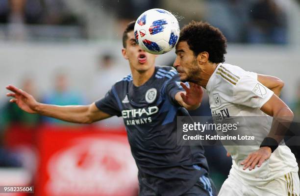Omar Gaber of Los Angeles FC and Jesus Medina of New York City FC fight for control of the ball at Banc of California Stadium on May 13, 2018 in Los...