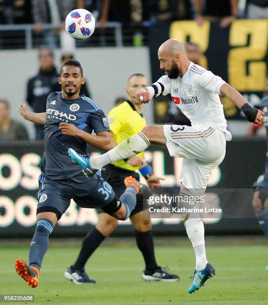 Yangel Herrera of New York City FC and Laurent Ciman of Los Angeles FC fight for control of the ball at Banc of California Stadium on May 13, 2018 in...
