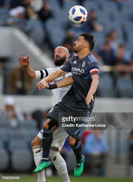 Laurent Ciman of Los Angeles FC and David Villa of New York City FC fight for control of the ball at Banc of California Stadium on May 13, 2018 in...