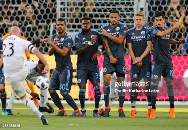 Laurent Ciman of Los Angeles FC kicks a free kick as Yangel Herrera, Sebastien Ibeagha, Alexander Callens, Alexander Ring, and Jesus Medina of New...