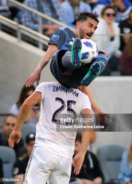 David Villa of New York City FC falls over Walker Zimmerman of Los Angeles FC at Banc of California Stadium on May 13, 2018 in Los Angeles,...