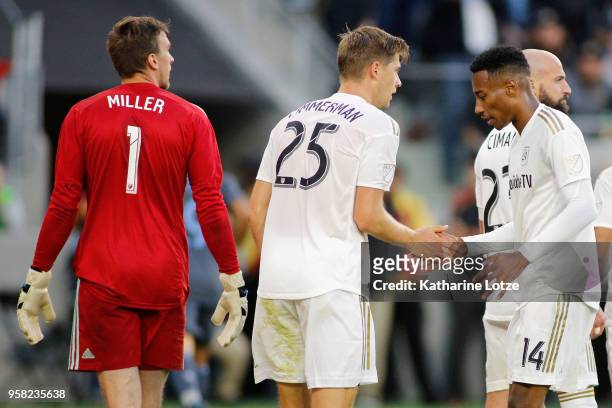 Tyler Miller, Walker Zimmerman, and Mark-Anthony Kaye of Los Angeles high-five at Banc of California Stadium on May 13, 2018 in Los Angeles,...