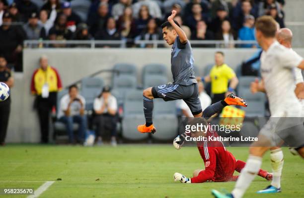 Jesus Medina of New York City FC and Tyler Miller of Los Angeles FC fight for control of the ball at Banc of California Stadium on May 13, 2018 in...