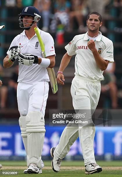 Kevin Pietersen of England looks dejected as Wayne Parnell of South Africa celebrates taking his wicket for 12 runs when he was caught behind by Mark...