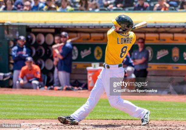 Oakland Athletics Second base Jed Lowrie takes a cut at the ball during the game between the Houston Astros and the Oakland Athletics on May 9, 2018...