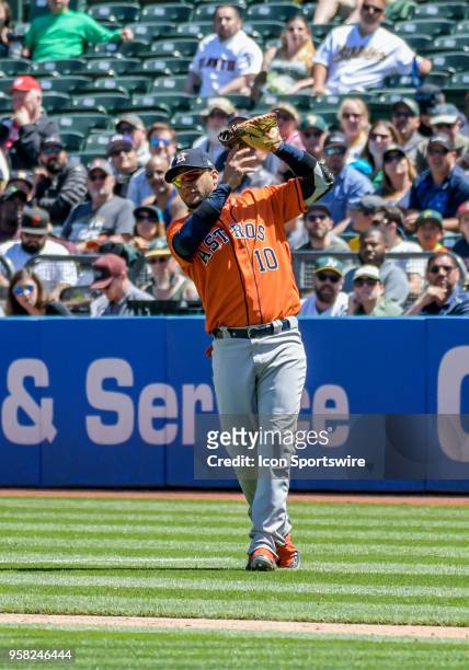 Houston Astros First base Yuli Gurriel makes a catch just past the infield during the game between the Houston Astros and the Oakland Athletics on...