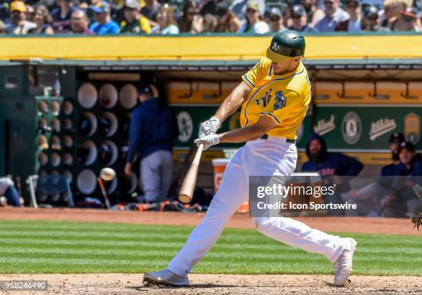 Oakland Athletics Outfield Mark Canha connects for a base hit during the game between the Houston Astros and the Oakland Athletics on May 9, 2018 at...