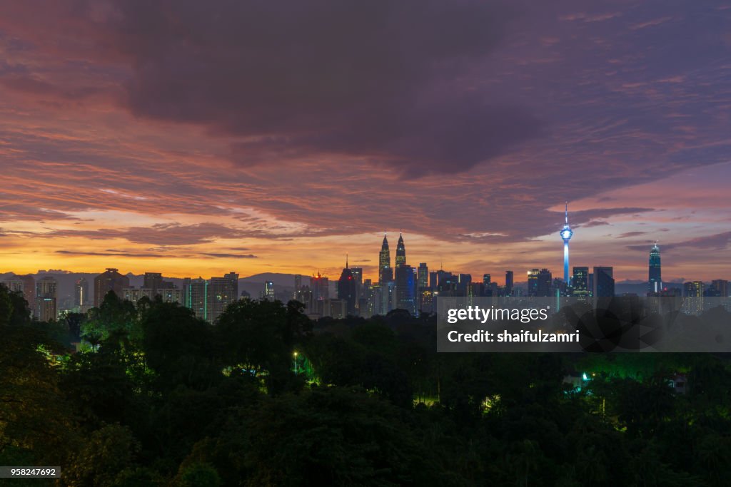 Majestic sunrise over Petronas Twin Towers and surrounded buildings in downtown Kuala Lumpur, Malaysia.