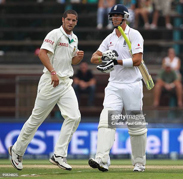 Kevin Pietersen of England looks dejected as Wayne Parnell of South Africa celebrates taking his wicket for 12 runs when he was caught behind by Mark...