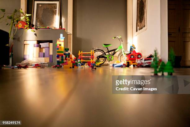 bicycle and toys in living room - messy - fotografias e filmes do acervo