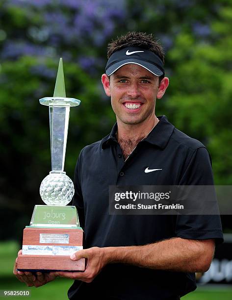 Charl Schwartzel of South Africa holds the winner's trophy at the Joburg Open at Royal Johannesburg and Kensington Golf Club on January 17, 2010 in...