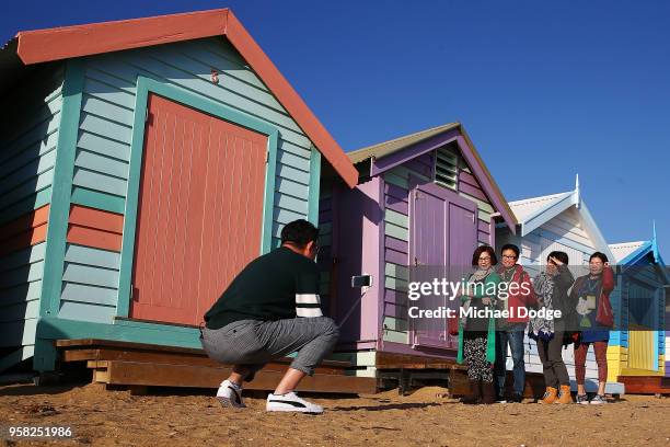 Tourists take photos at the bathing boxes on Brighton Beach on May 14, 2018 in Melbourne, Australia. The spot is popular with locals and tourists and...