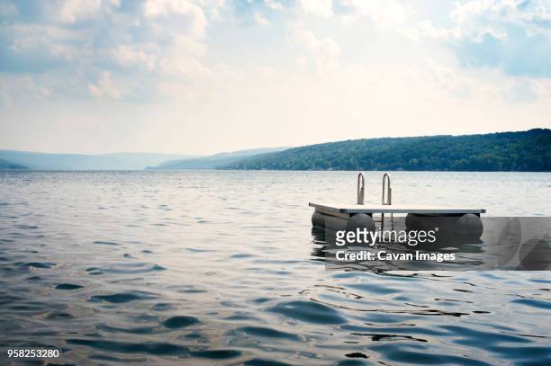 floating platform on lake against sky - floating moored platform stock pictures, royalty-free photos & images