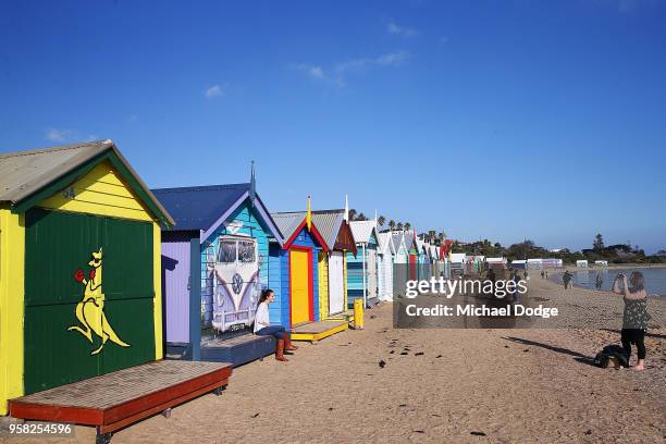 The Boxing Kangaroo bathing box is seen as an American and New Zealand tourist take photos at the bathing boxes on Brighton Beach on May 14, 2018 in...