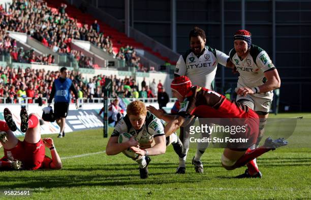 Irish winger Tom Homer dives over to score during the Heineken Cup Pool 6 Round 5 match between Scarlets and London Irish at Parc y Scarlets on...