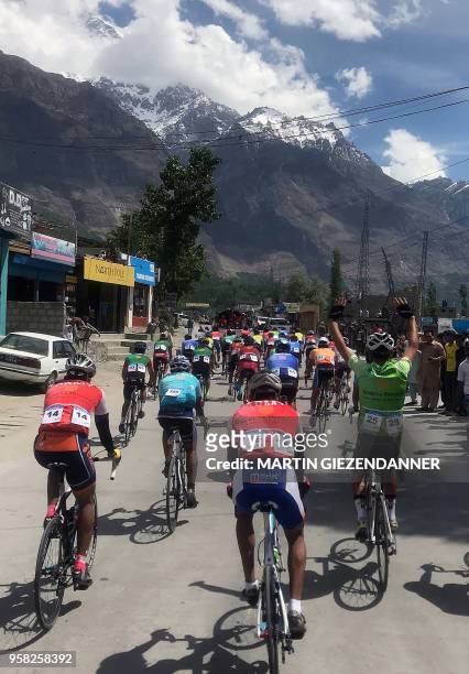This picture taken on May 12 shows Pakistani and foreign cyclists taking part in a race of 'Tour de Khunjerab' in Pakistan's northern Aliabad area in...