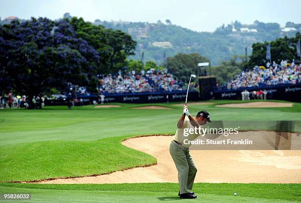 Hennie Otto of South Africa plays his approach shot on the 18th hole during the final round of the Joburg Open at Royal Johannesburg and Kensington...