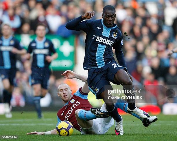 West Ham's English striker Frank Nouble vies with Aston Villa's Welsh defender James Collins during their English Premier League football match at...