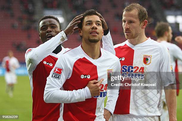 Marcel Ndjeng of Augsburg celebrates the third goal with Andrew Sinkala and Sándor Torghelle during the Second Bundesliga match between FC Augsburg...