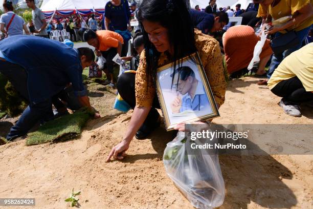 Attendees run to collect 'sacred' rice grains from the ground after the Royal Ploughing Ceremony at the Sanam Luang park in Bangkok, Thailand on May...