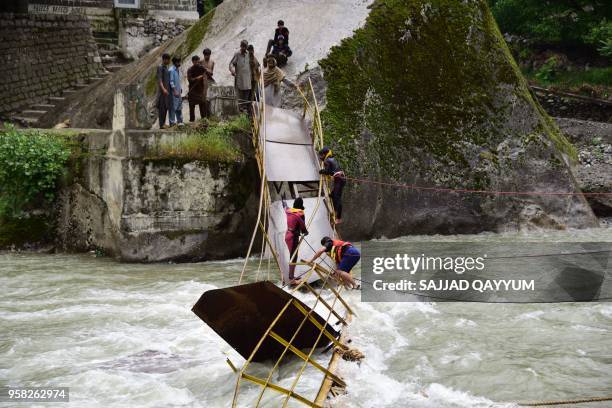 In this picture taken on May 13 Pakistani rescuers search for missing university students after a bridge collapsed in Kundal Shahi, Neelum district....