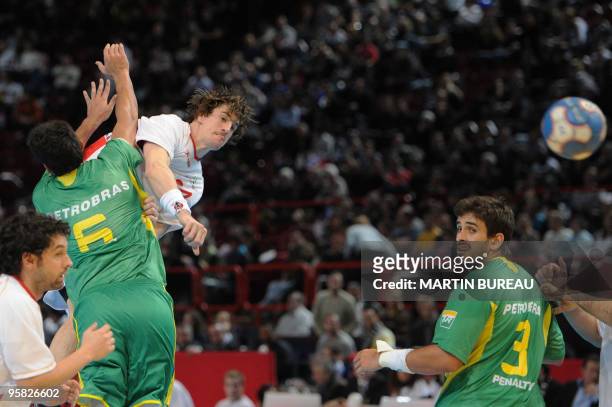 Spanish player Viran Morros-De-Argila tries to score despite of Brazilian defenders on January 17, 2010 in Paris, during the match between Spain and...