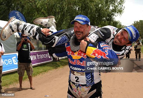 France's Cyril Despres is congratulated by his friend and former rugby player Christian Califano after the 14th stage of the Dakar 2010, between...