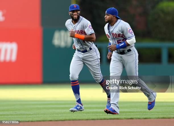 Amed Rosario and Yoenis Cespedes of the New York Mets warmup before a game against the Philadelphia Phillies at Citizens Bank Park on May 11, 2018 in...