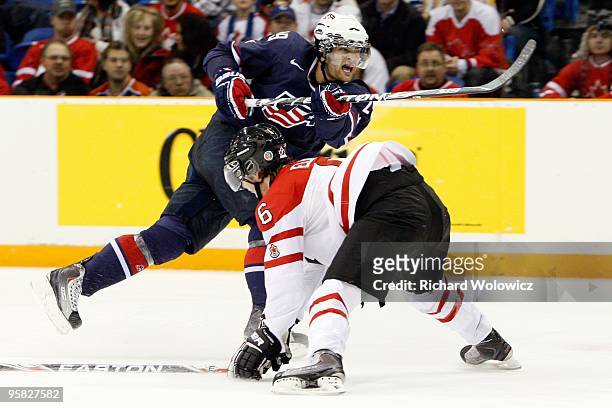 Jerry D'Amigo of Team USA shoots the puck in front of Ryan Ellis of Team Canada during the 2010 IIHF World Junior Championship Tournament game on...