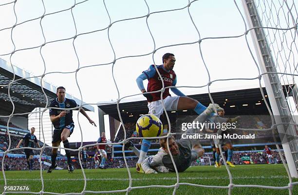 John Carew of Aston Villa lifts the ball over Robert Green of West Ham Uniteds head to score a goal but it is not given as he is off side during the...