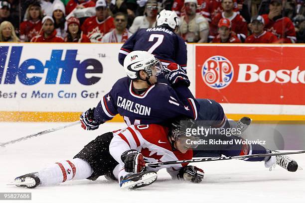 John Carlson of Team USA falls on top of Brayden Schenn of Team Canada during the 2010 IIHF World Junior Championship Tournament game on December 31,...