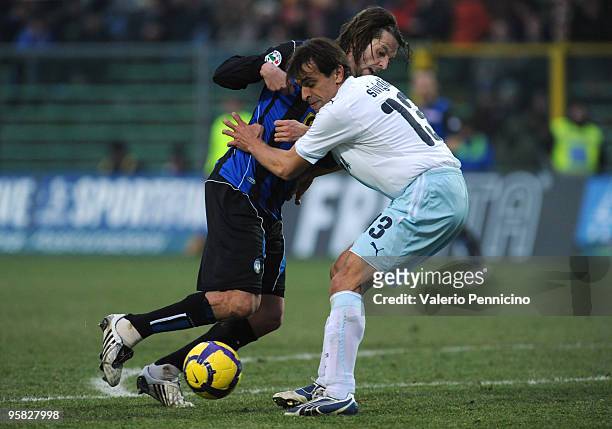 Cristiano Doni of Atalanta BC is challenged by Sebastiano Siviglia of SS Lazio during the Serie A match between Atalanta BC and SS Lazio at Stadio...