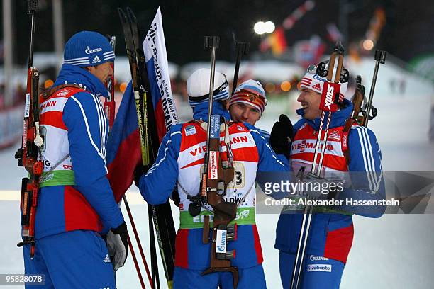 Evgeny Ustygov of Russia celebrates winning with his team mates Anton Shipulin , Maxim Tchoudov and Ivan Tcherezov after the Men's 4 x 7,5km Relay in...