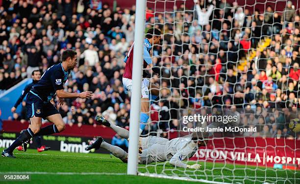 John Carew of Aston Villa lifts the ball over Robert Green of West Ham Uniteds head to score a goal but it is not given as he is off side during the...
