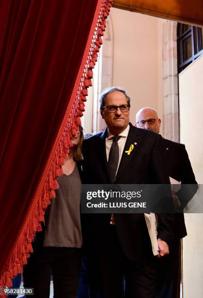 Junts per Catalonia MP and presidential candidate Quim Torra and Junts per Catalonia MP Eduard Pujol arrive to attend a vote session to elect a new...